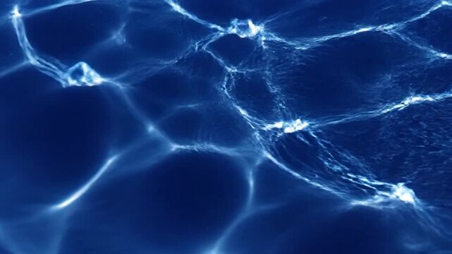Abstract deep blue water surface with bright caustic light patterns
