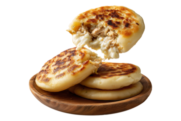 Grilled arepas plain sandwich filled with melted cheese and ground beef on wooden plate, isolated on white transparent background, concept of Latin street food