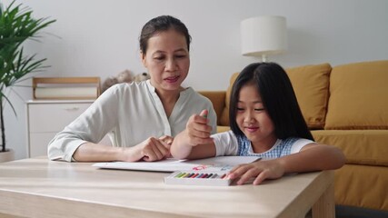 Asian family drawing picture together at home, colorful pencil art notebook - Powered by Adobe