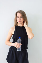 Fit Woman Hydrating with Water Bottle After Workout