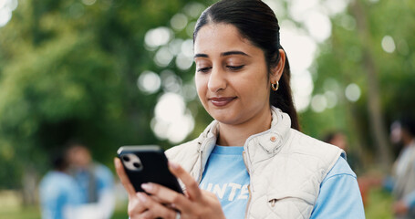 Phone, woman and volunteer in nature for networking, contact or social media post for outreach. Happy, outdoor and female ngo worker with cellphone for communication with community service in park.