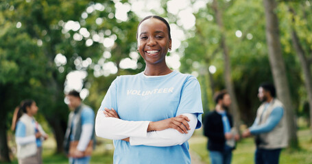 Arms crossed, volunteer and portrait with woman in park for donation, community service and ngo project. Nonprofit pride, grocery distribution and food drive with person outdoor for outreach program