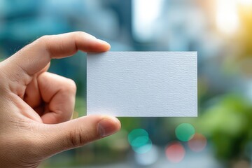 Hand holding blank business card  