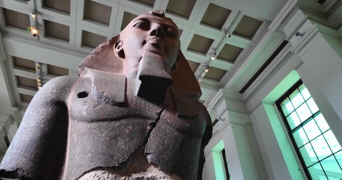 Orbital and detailed shot in 4k of an Egyptian sphinx displayed inside the British Museum in London, highlighting texture, craftsmanship, and ancient artistic heritage.