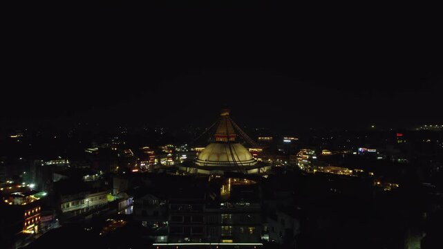A serene night drone view of Boudhanath Stupa, a UNESCO world heritage site. The sacred Buddhist landmark glows beautifully above Kathmandu&rsquo;s peaceful evening skyline.