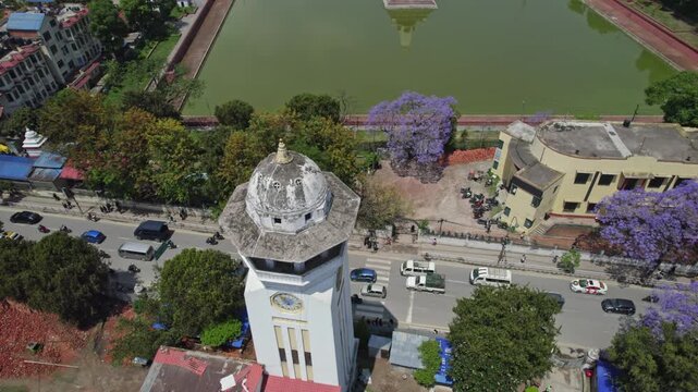 Drone view of Kathmandu Valley featuring Rani Pokhari, Ghantaghar, and blooming Jacaranda flowers, showcasing the valley&rsquo;s rich heritage, colors, and timeless urban charm.