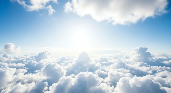 Blue sky with bright sun and fluffy clouds