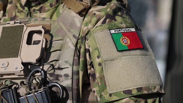 Details with the uniform of a Portuguese soldier in combat gear.