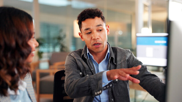 Businessman, night and coaching with intern for junior web development or software update in office. Man, employee or discussion with candidate on computer for tasks, system process or internship