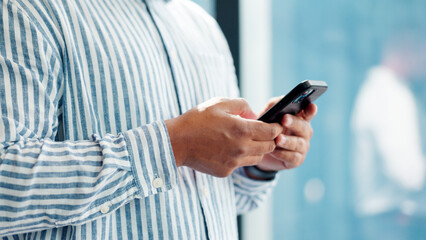 Hands, phone and typing with business person in glass office for financial feedback or update. App, finance and text message with employee in corporate workplace for accounting or risk management