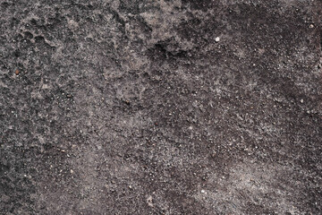 Dark rock terrain with visible gravel