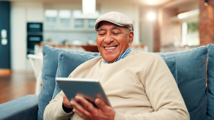 Tablet, relax and senior man on sofa in home with networking, social media or blog post. Happy, digital technology and elderly male person in living room for reading news headline on app in house.