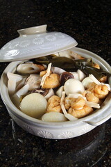 Oden, a Japanese stew with white daikon radish, potatoes, kombu seaweed, eggs, konnyaku, fried tofu, chikuwa, kamaboko, yam, and carrot.
