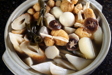 Oden, a Japanese stew with white daikon radish, potatoes, kombu seaweed, eggs, konnyaku, fried tofu, chikuwa, kamaboko, yam, and carrot.