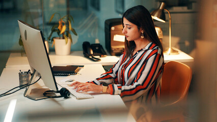 Night, employee and woman with computer, office and journalist with story for magazine and...