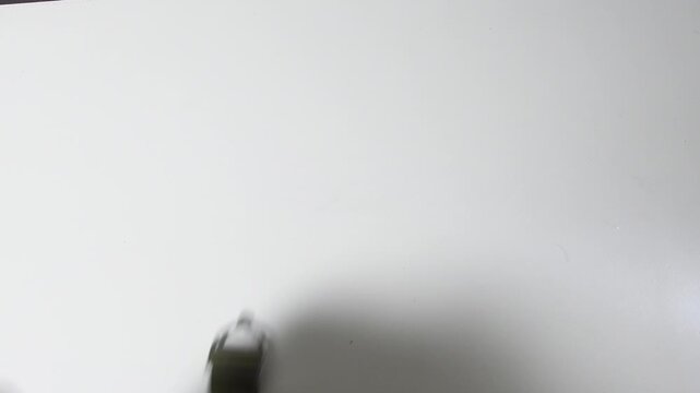 Old gas mask on a white surface showing details of its worn appearance and unique shape from a past era