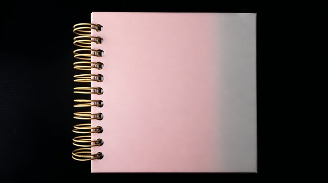 A notebook with a minimalist aesthetic and an open ring binder lies on a black surface