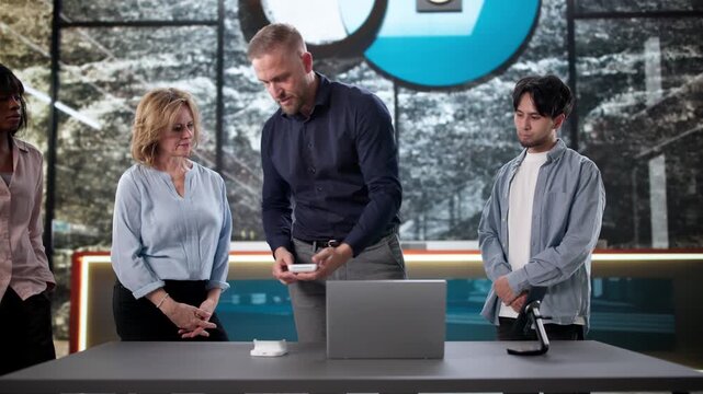 Front Desk Staff Members Observe A Trainer Demonstration Of Keycard Encoder