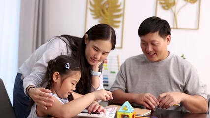 Asian Family Enjoys Creative Learning Together at Home Table