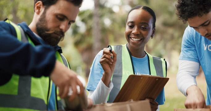Clipboard, outdoor or volunteer people with paper bag, community service or packaging for charity drive. Teamwork, non profit or woman with donation list for food security crisis, inspection or park - Powered by Adobe