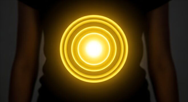 Radiant yellow circles glowing around a person’s belly in darkness
