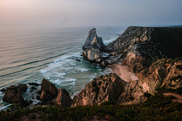 rocks in the sea Displays a rocky coastal scene with waves. Full-frame composition, blue-brown tone. Realistic style, coastal background