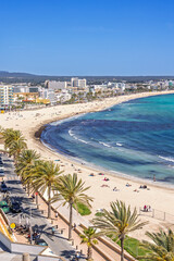 View at the beach at a resort at Can Pastilla on Mallorca with tourists on the beach