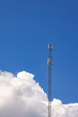 High mobile mast at a blue sky