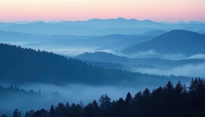 Fototapeta premium Blue mountain ranges stack in beautiful morning landscape. Thick fog fills forest valleys between hills. Sky shows soft pink colors at dawn over serene natural scene. Peaceful wilderness view with