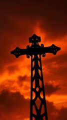 Silhouette of Faith: A striking silhouette of a religious cross stands tall against a fiery orange sky, embodying faith and spirituality. 