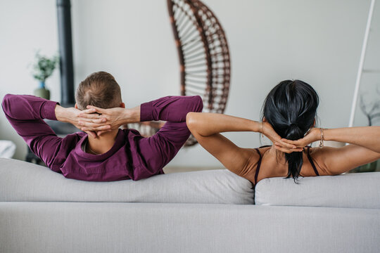 A couple posing for a playful selfie in a bright kitchen, showing surprise and excitement, capturing a spontaneous and lively moment.