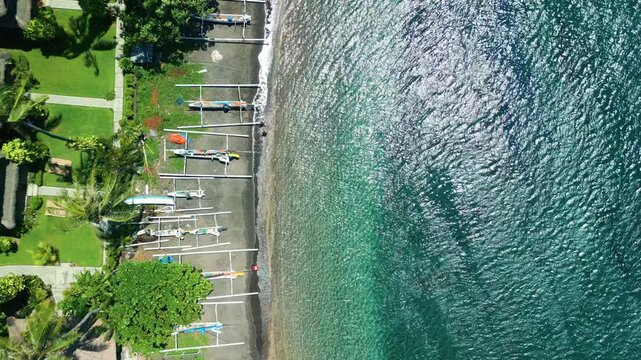Aerial Top-Down View Of Amed Beach With Traditional Boats And Clear Water