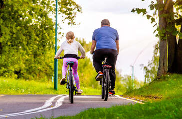 Fototapeta premium Cyclists ride on the bike path in the city Park 