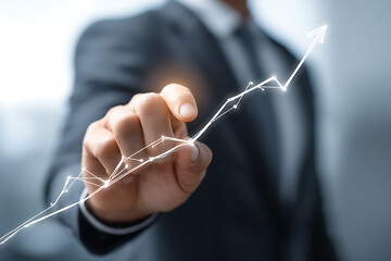 ビジネスパーソンが上昇トレンドの抽象チャートを指し示すビジネス成長イメージ