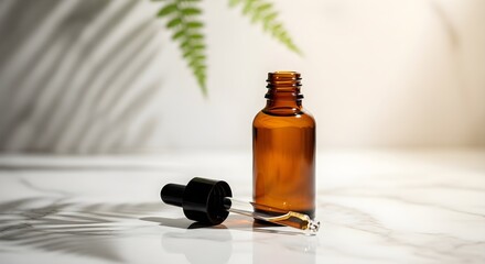 A brown glass bottle with a dropper next to it is lit by sunlight.