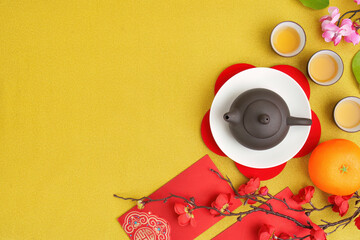 Naklejka premium Chinese New Year tea ceremony with traditional teapot and festive decorations