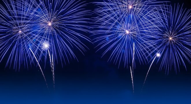 Brilliant blue fireworks exploding against a dark night sky background