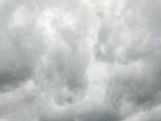 A uniform expanse of gray, cloudy sky, featuring a soft diffusion of light and varied cloud textures, indicative of an overcast weather condition.