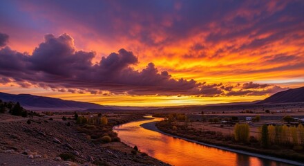 Vibrant sunset colors over a winding river in a serene landscape during autumn