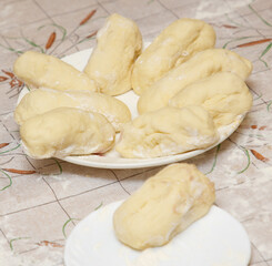 A plate of doughnuts with a white plate underneath