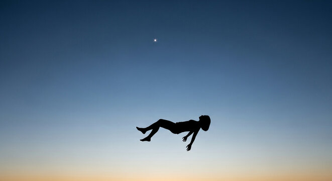 Mysterious silhouette of floating person against clear sky
- Powered by Adobe