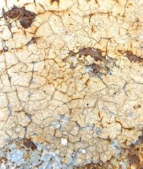 A wall with cracks and holes in it