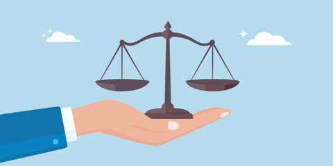 Hand holding scales of justice concept of fairness and balance in law