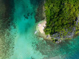 Boat over turquoise sea water in Bukal Island. El Nido, Palawan. Philippines.