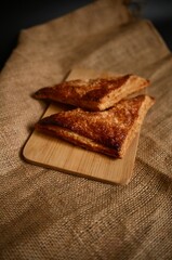 Warm and inviting image of golden puff pastries. Perfect for promoting bakery products, desserts, and traditional, rustic food themes with rich, earthy tones.