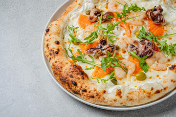 Fresh seafood pizza features shrimp, octopus, and arugula, perfect for a savory meal