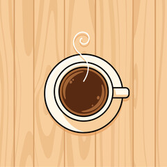 Overhead view of a cup of coffee on a wooden surface.