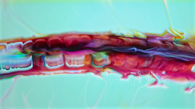 Vibrant abstract acrylic paint creating organic flowing color patterns