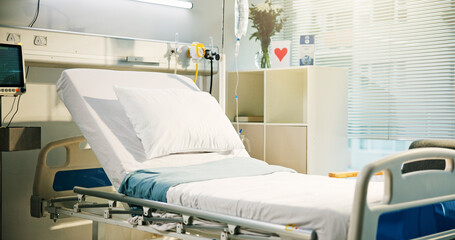 Healthcare, empty ward and bed in hospital with card, flowers and equipment for recovery. Room, healing and interior of intensive care unit for admission with furniture at medical facility or clinic.