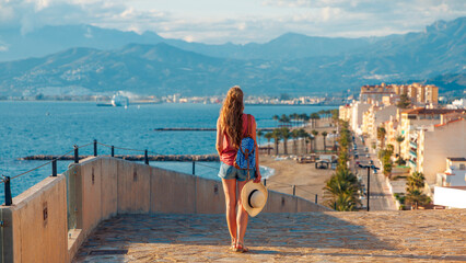 A woman enjoying panoramic view of costa tropical in Spain, travel destination Granada province, typical village of Torrenueva